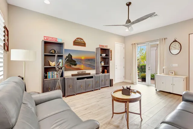 a dining room with furniture a chandelier and wooden floor