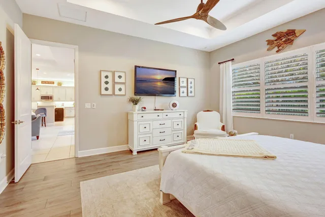 a front view of a house with a yard and potted plants