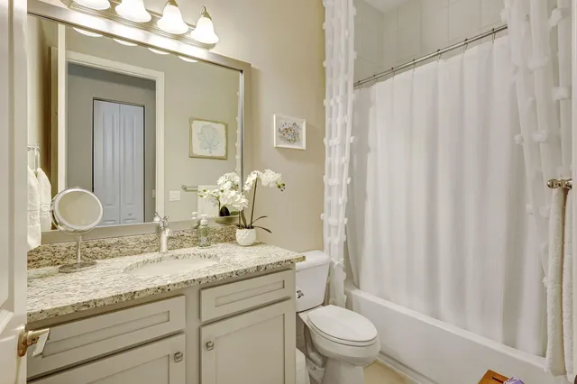 a street sign on a wall next to a road