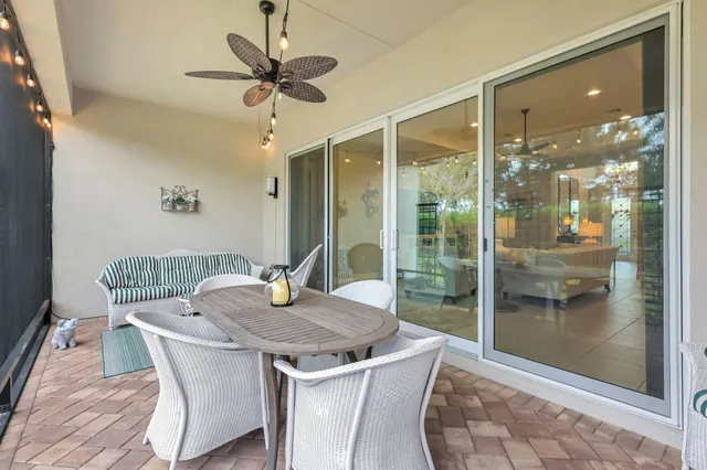 a living room with furniture chandelier and a large window