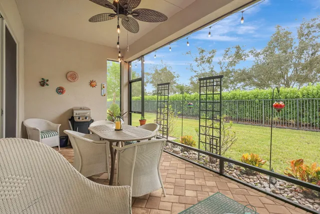 a living room with furniture a chandelier and a large window