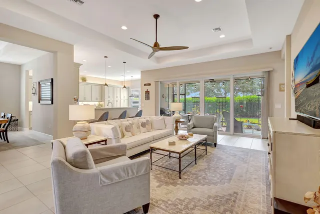 a kitchen with kitchen island granite countertop a table chairs sink and cabinets