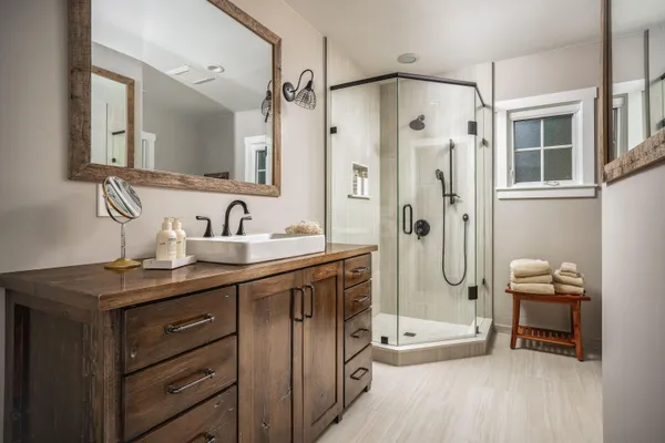 a spacious bathroom with a double vanity sink mirror and shower
