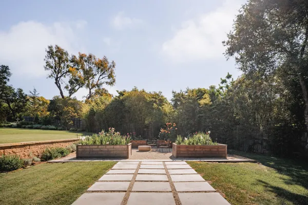 a view of a yard with a fountain and a pathway