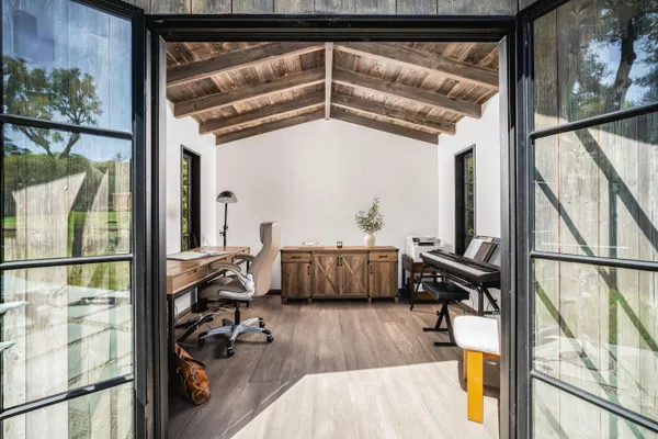 a view of living room with furniture and wooden floor