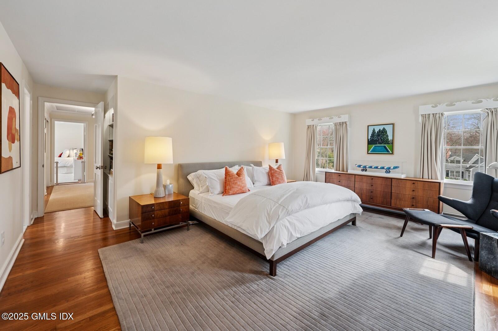 6 Pilgrim Road Darien, CT 06820 - Photo 12 of 23 a spacious bedroom with a bed a couch and a window