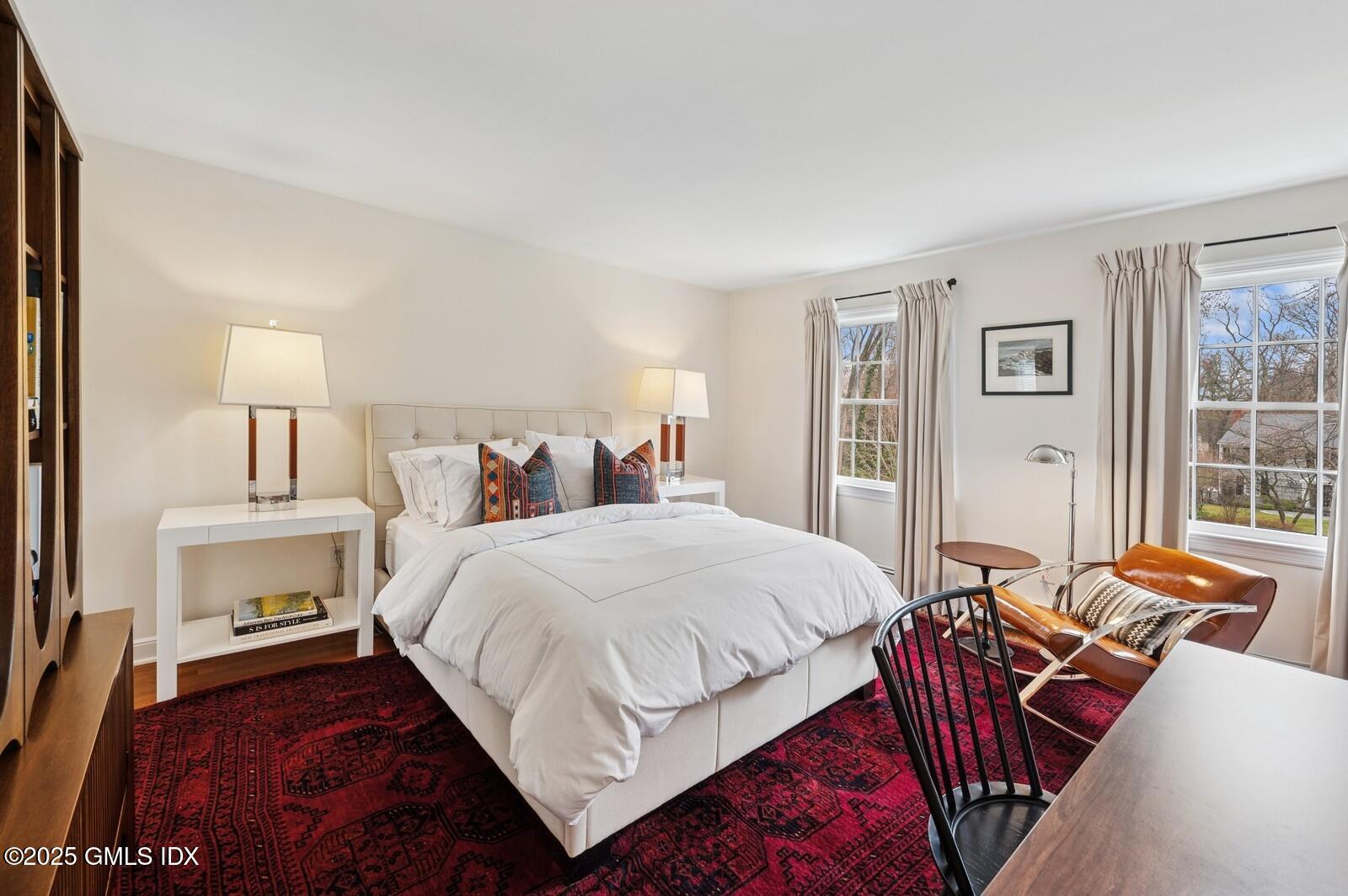 6 Pilgrim Road Darien, CT 06820 - Photo 18 of 23 a bedroom with a bed and wooden floor