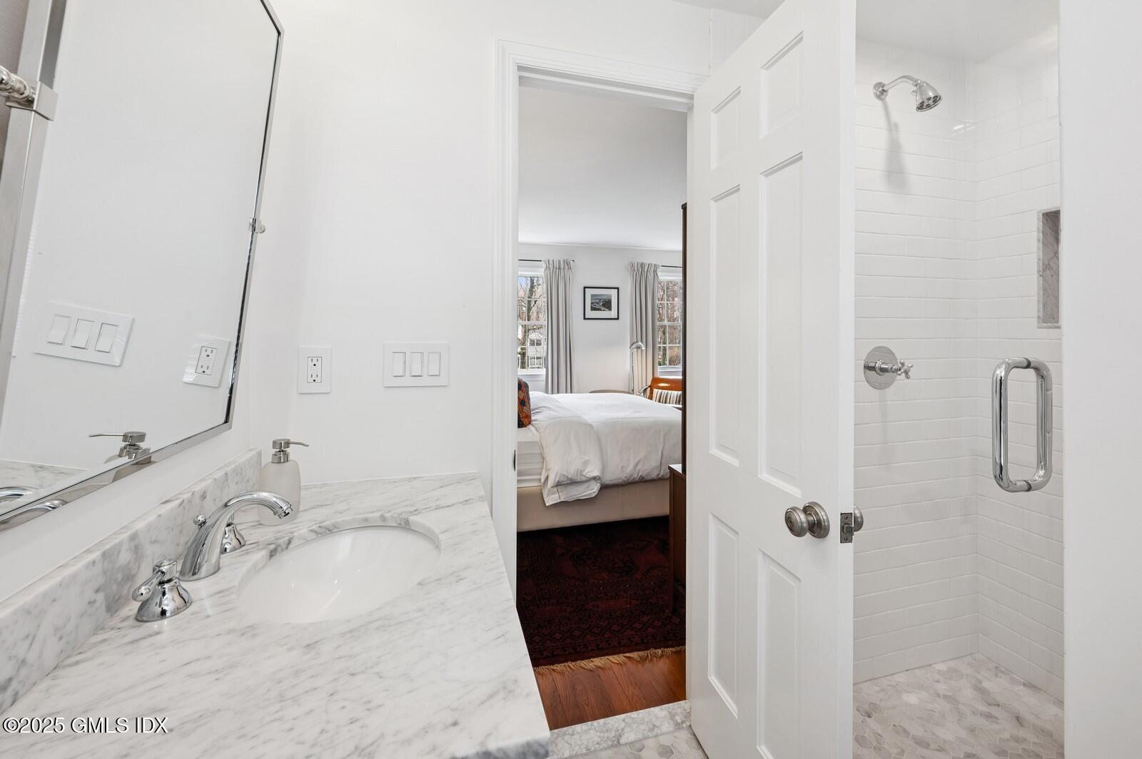 6 Pilgrim Road Darien, CT 06820 - Photo 19 of 23 a bathroom with a granite countertop shower sink and vanity