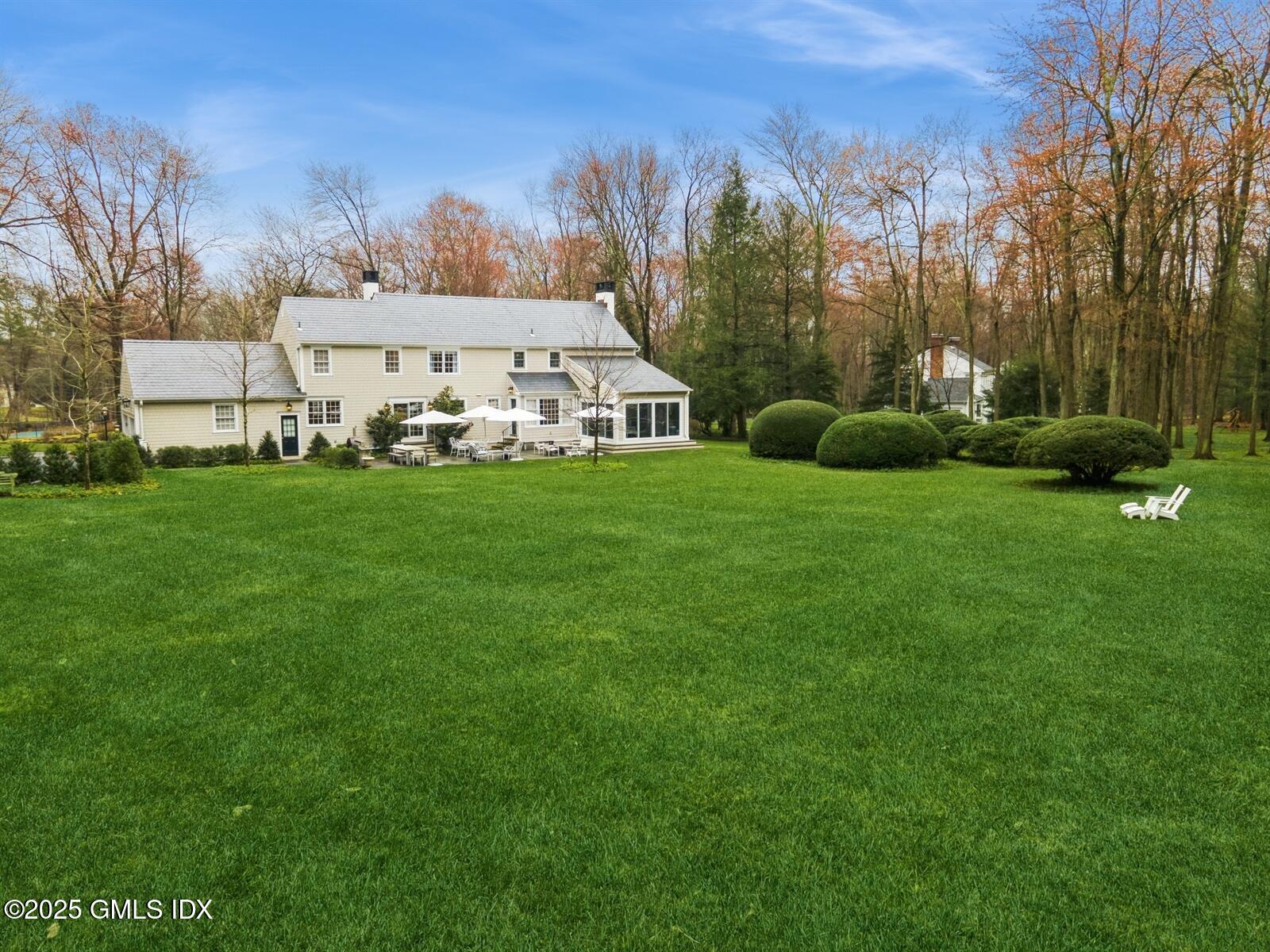 6 Pilgrim Road Darien, CT 06820 - Photo 23 of 23 a view of a big yard with plants and large trees