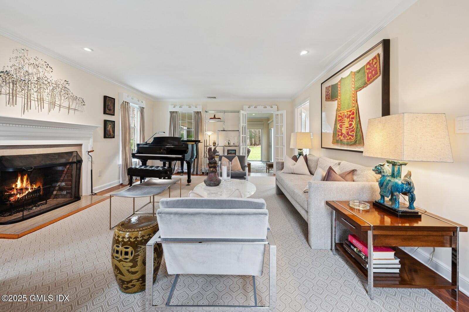 6 Pilgrim Road Darien, CT 06820 - Photo 4 of 23 a living room with furniture a fireplace and a table