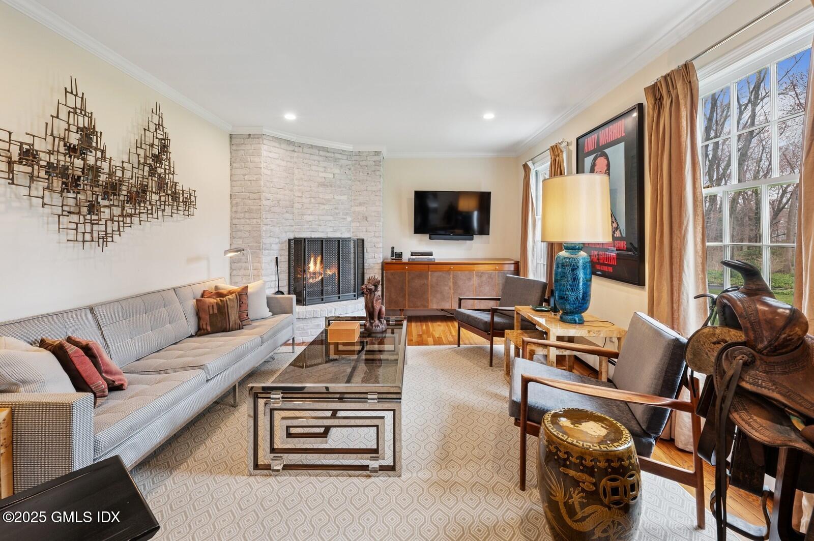 6 Pilgrim Road Darien, CT 06820 - Photo 6 of 23 a living room with furniture a flat screen tv and a fireplace