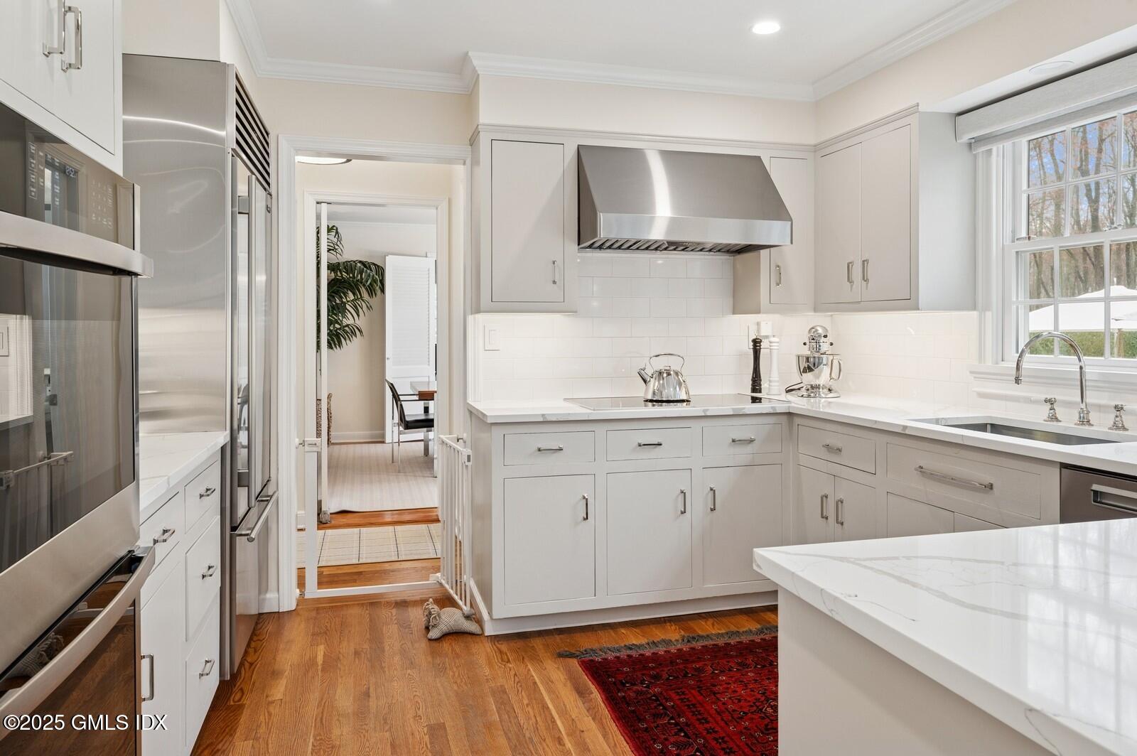 6 Pilgrim Road Darien, CT 06820 - Photo 9 of 23 a kitchen with a stove a sink and a refrigerator