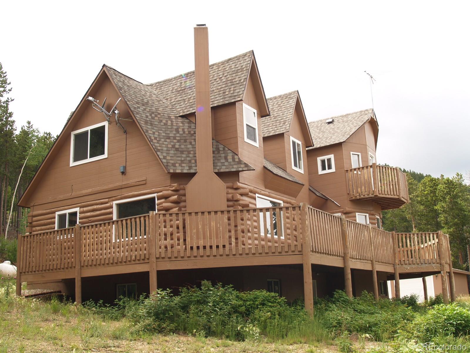 a large brick building with a small yard and wooden fence