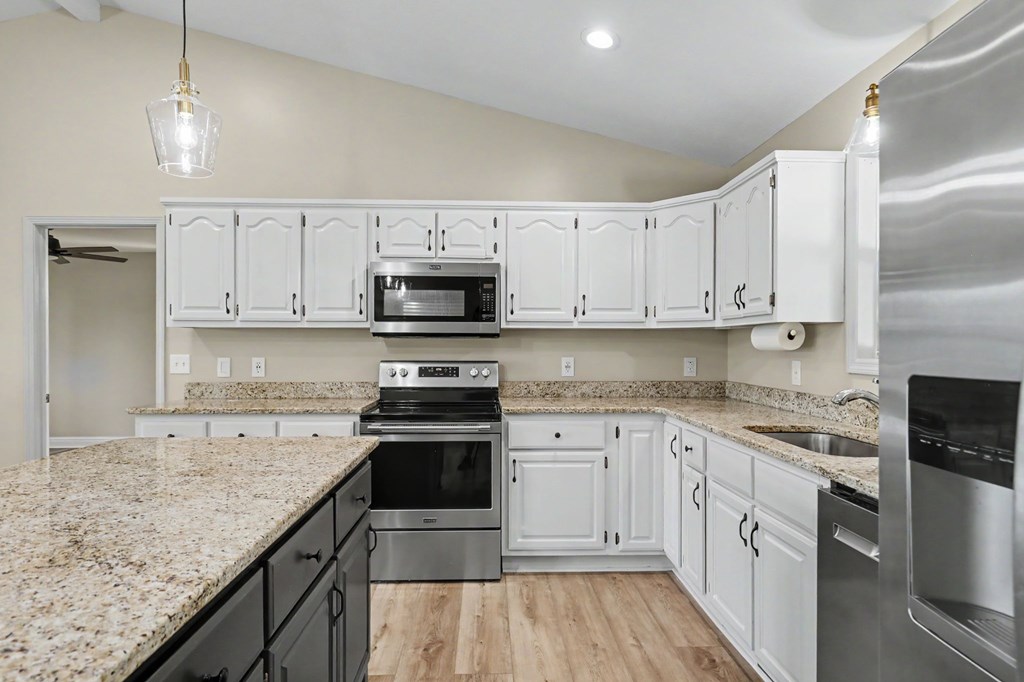 456 Deaver Cove Road Blairsville, GA 30512 - Photo 14 of 83 a kitchen with stainless steel appliances granite countertop a stove a sink and a refrigerator