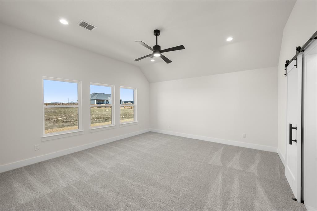 4867 Prairie Sky Lane DISH, TX 76247 - Photo 21 of 27 an empty room with windows and fan