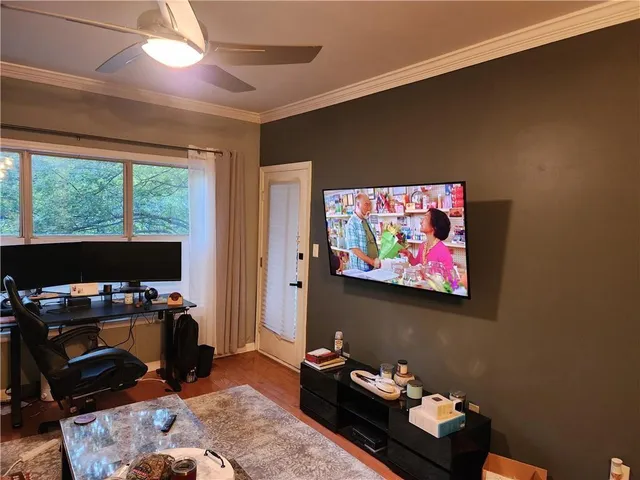 a bedroom with furniture and a flat screen tv
