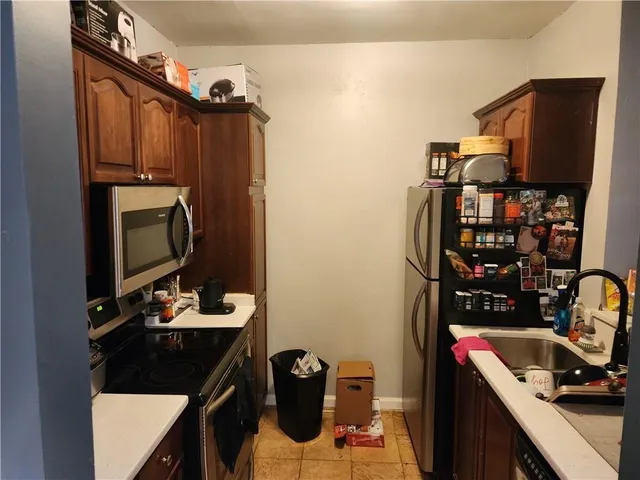 a kitchen with stainless steel appliances a refrigerator and a stove top oven