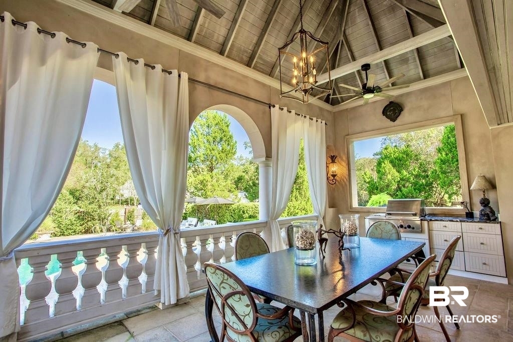 150 Austill Avenue Mobile, AL 36608 - Photo 34 of 39 Covered outdoor patio featuring a vaulted wood-plank ceiling, integrated ceiling fan, and ornate balustrade