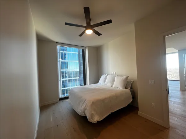 a bedroom with a bed and a large window