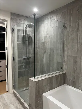 a bathroom with a shower and a tub