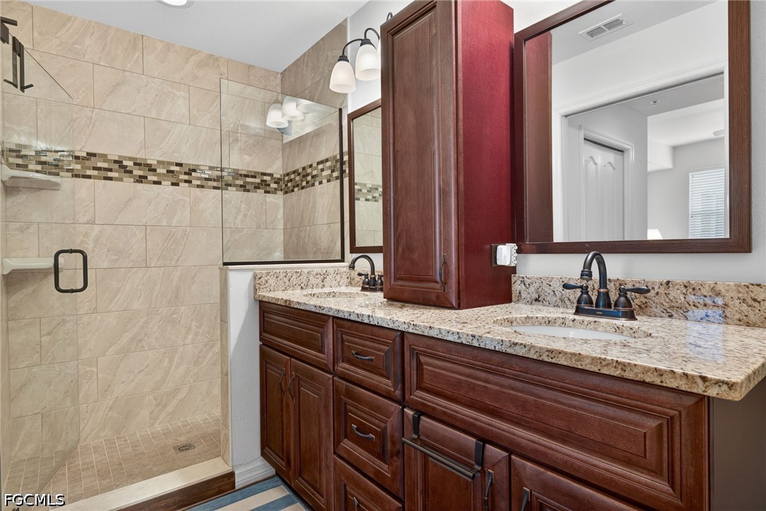 8251 Pathfinder Loop, Unit 621 Fort Myers, FL 33919 - Photo 18 of 30 a bathroom with a granite countertop sink and a mirror