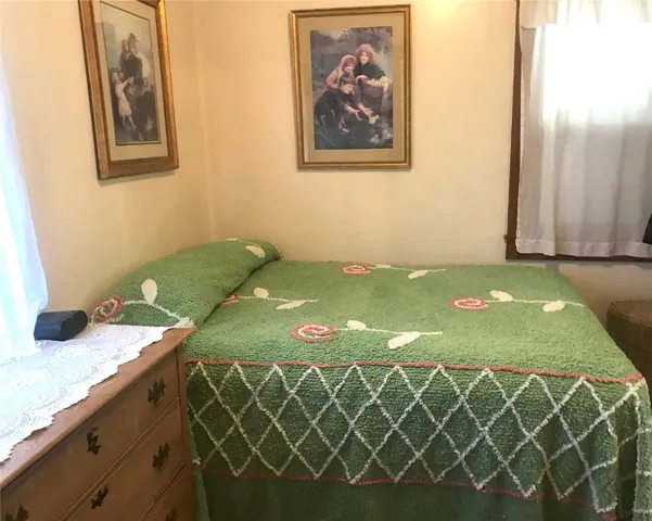 a bedroom with a bed and wall paintings