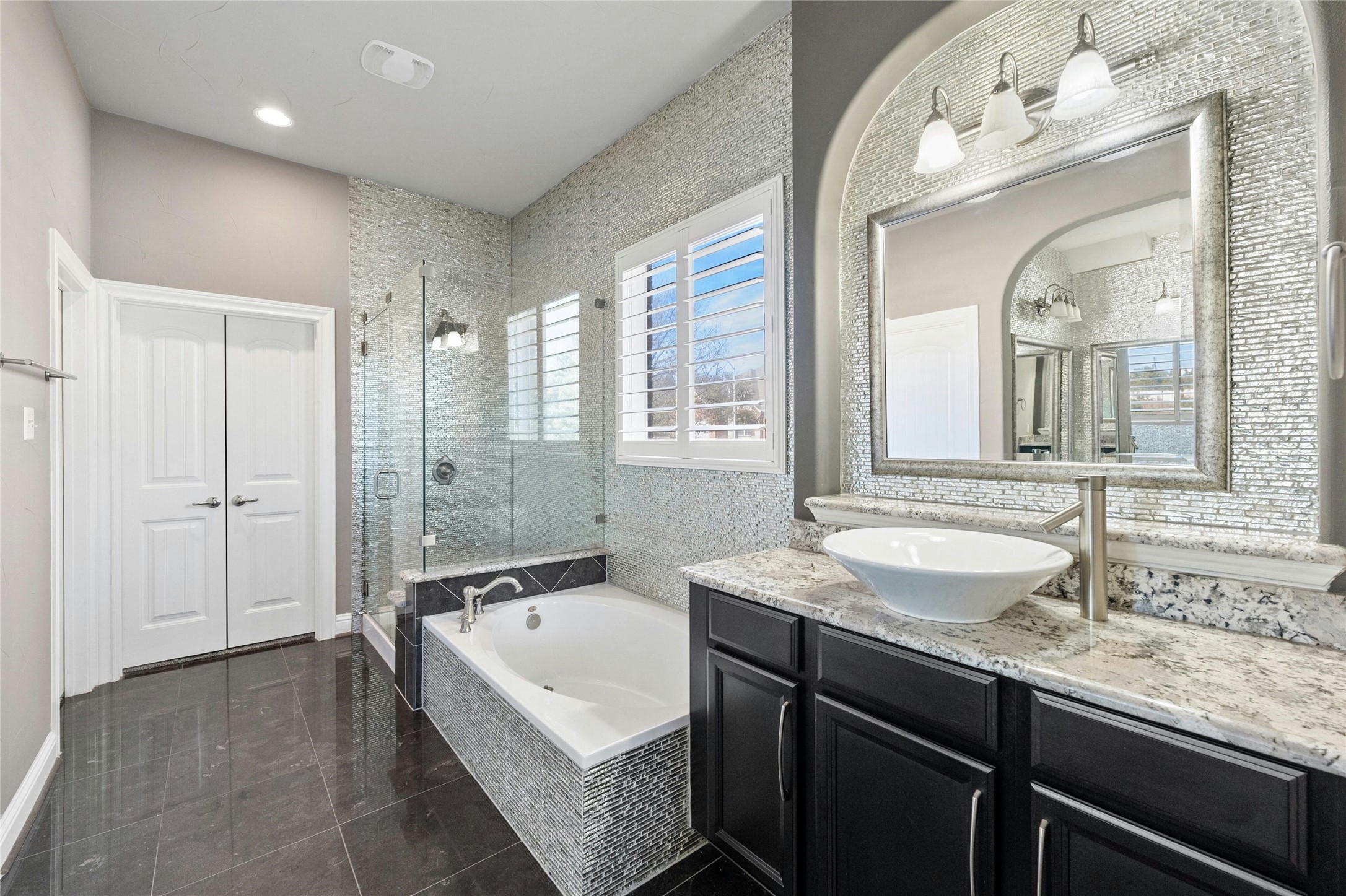 8501 High Summit Lane Austin, TX 78737 - Photo 16 of 38 a spacious bathroom with a granite countertop tub double vanity sink and a mirror