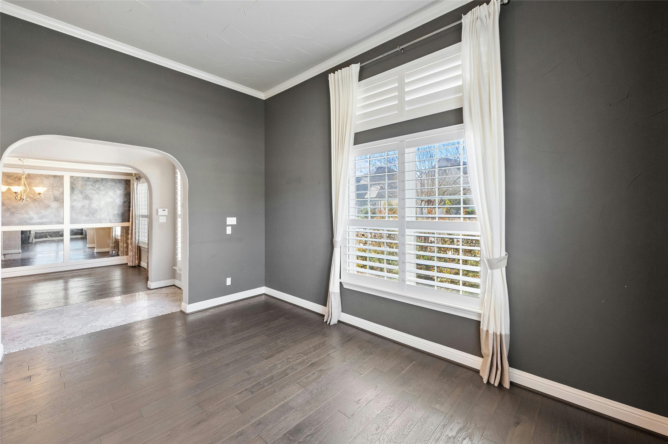 8501 High Summit Lane Austin, TX 78737 - Photo 21 of 38 a view of an empty room with wooden floor and a window