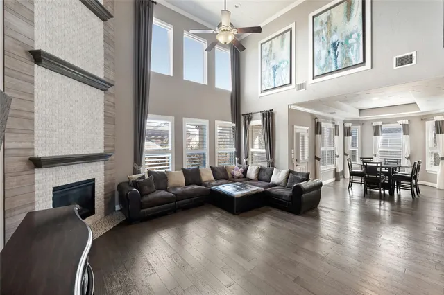 a living room with fireplace furniture and a large window