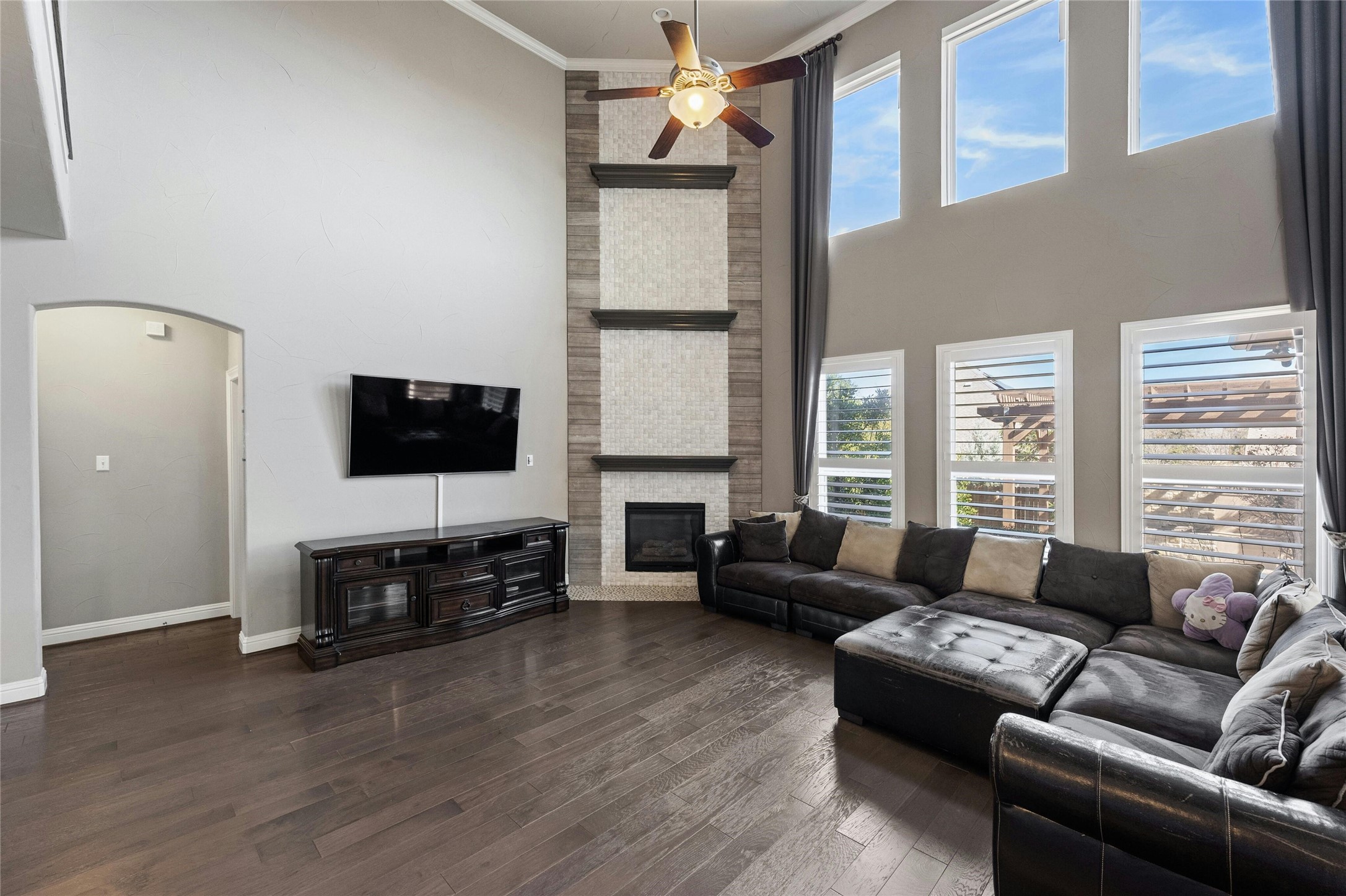 8501 High Summit Lane Austin, TX 78737 - Photo 4 of 38 a living room with furniture a flat screen tv and a fireplace