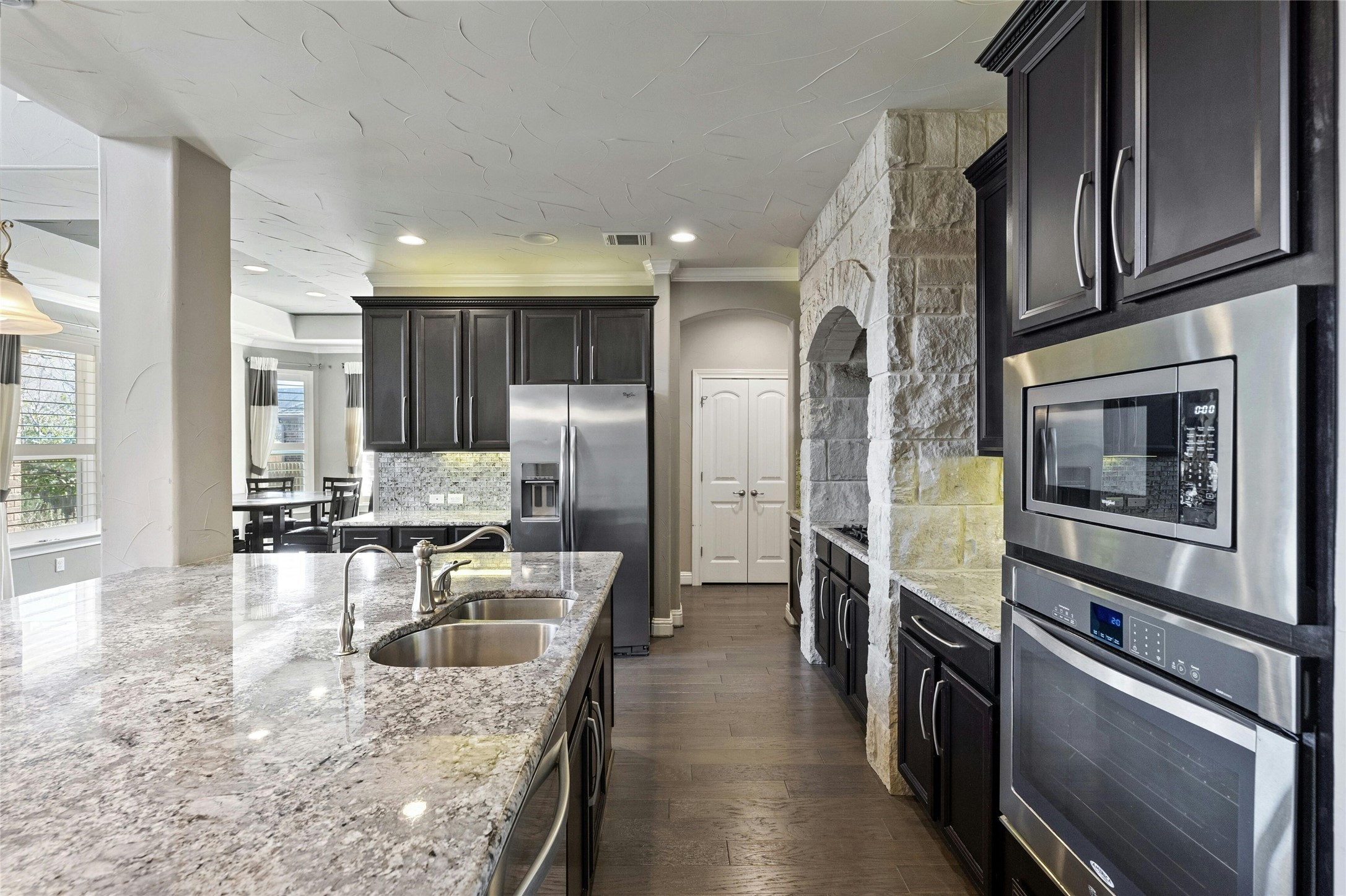 8501 High Summit Lane Austin, TX 78737 - Photo 9 of 38 a kitchen with stainless steel appliances granite countertop a sink a stove and a refrigerator