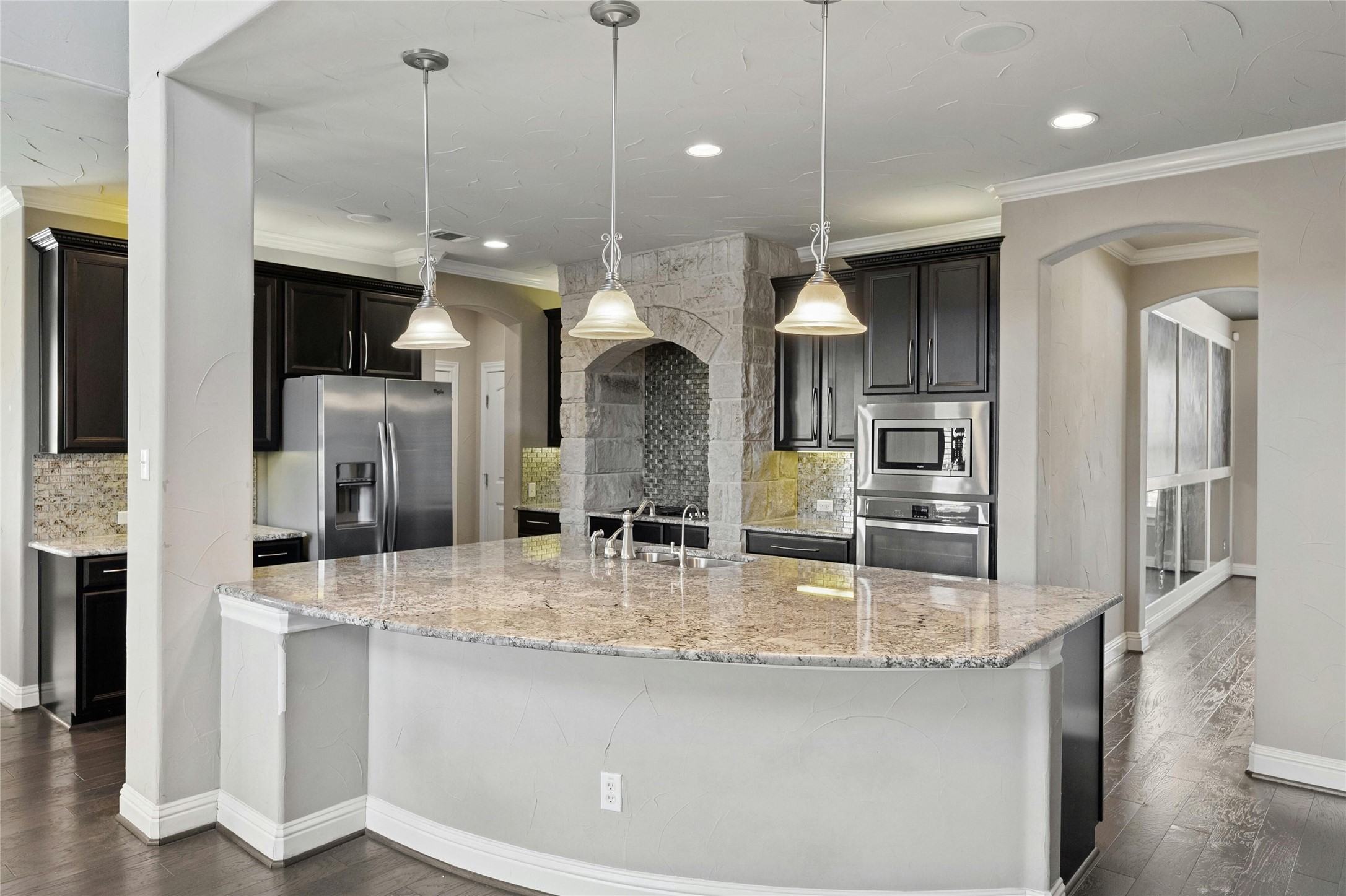 8501 High Summit Lane Austin, TX 78737 - Photo 10 of 38 a kitchen with stainless steel appliances granite countertop a sink a refrigerator and a view of living room