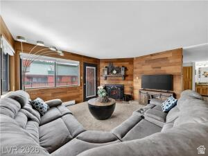 407 South Vasels Road, Unit 49 Brian Head, UT 84719 - Photo 8 of 40 Living area with wooden walls, a fireplace, and carpet