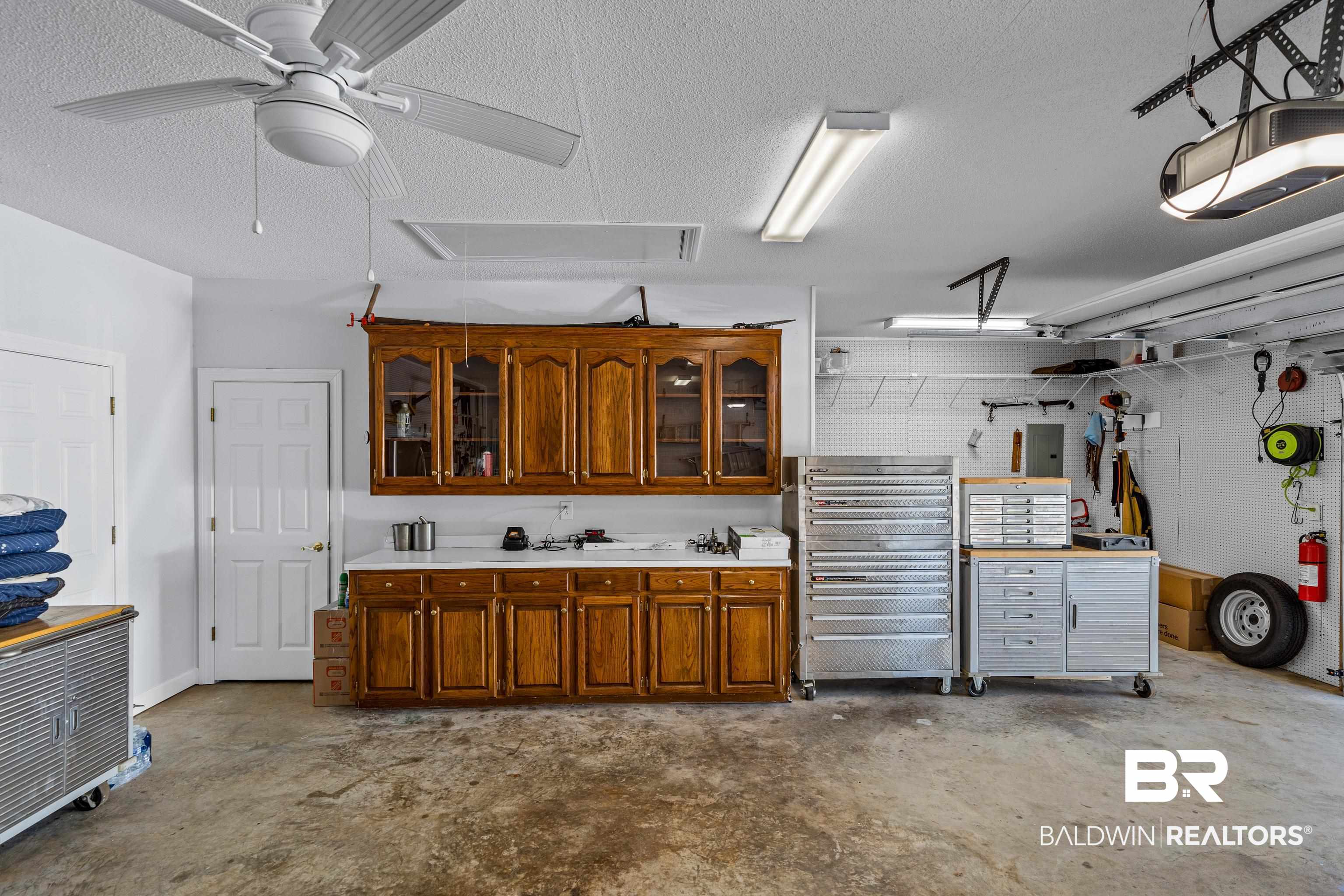31267 Blakeley Ridge Court Spanish Fort, AL 36527 - Photo 58 of 61 Garage featuring ceiling fan and a workshop area