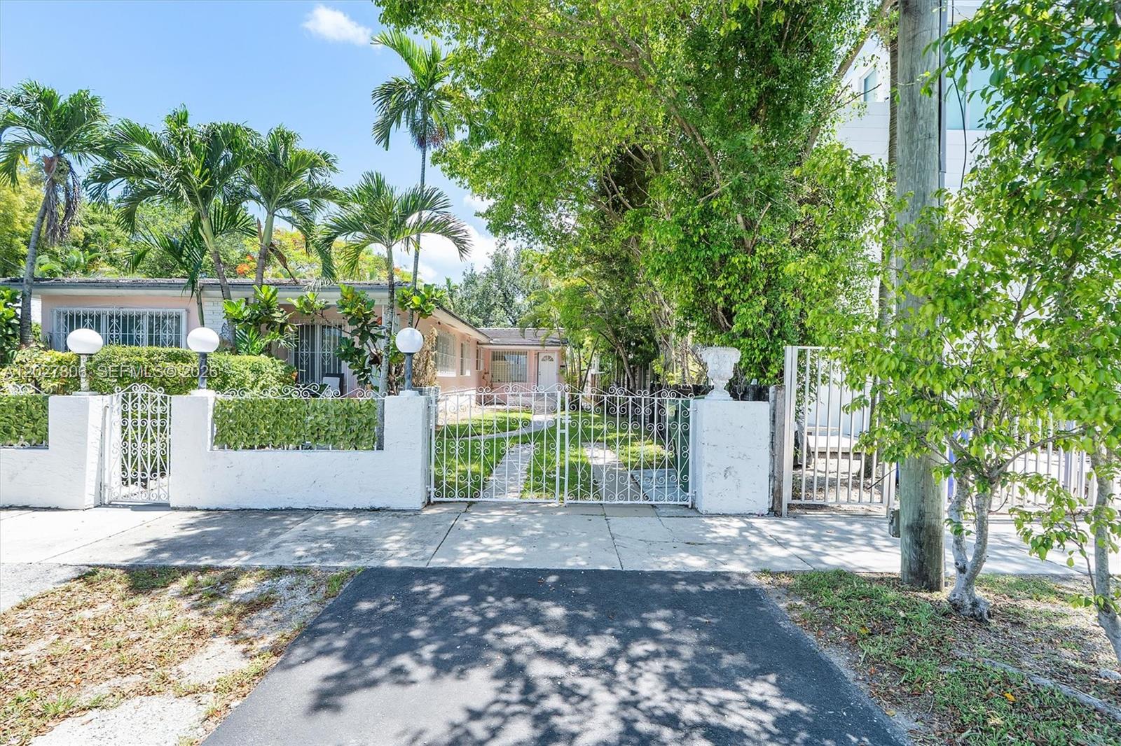 1612 Southwest 23rd Street, Unit 1612 Miami, FL 33145 - Photo 3 of 42 front view of a house with a yard and an trees