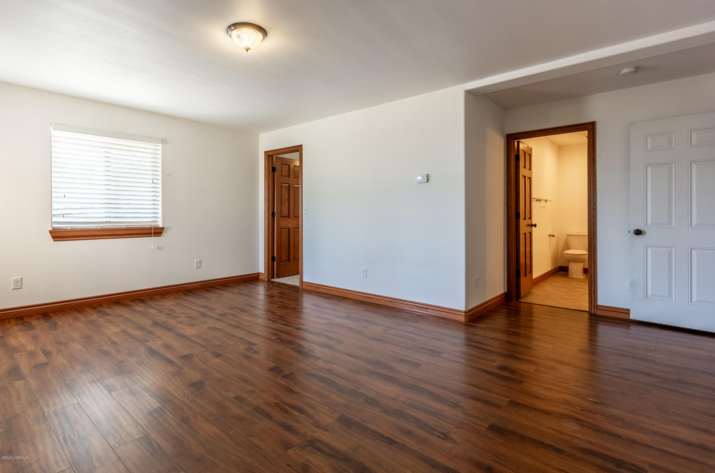 13351 Wide Hollow Road Yakima, WA 98908 - Photo 26 of 31 an empty room with wooden floor and windows