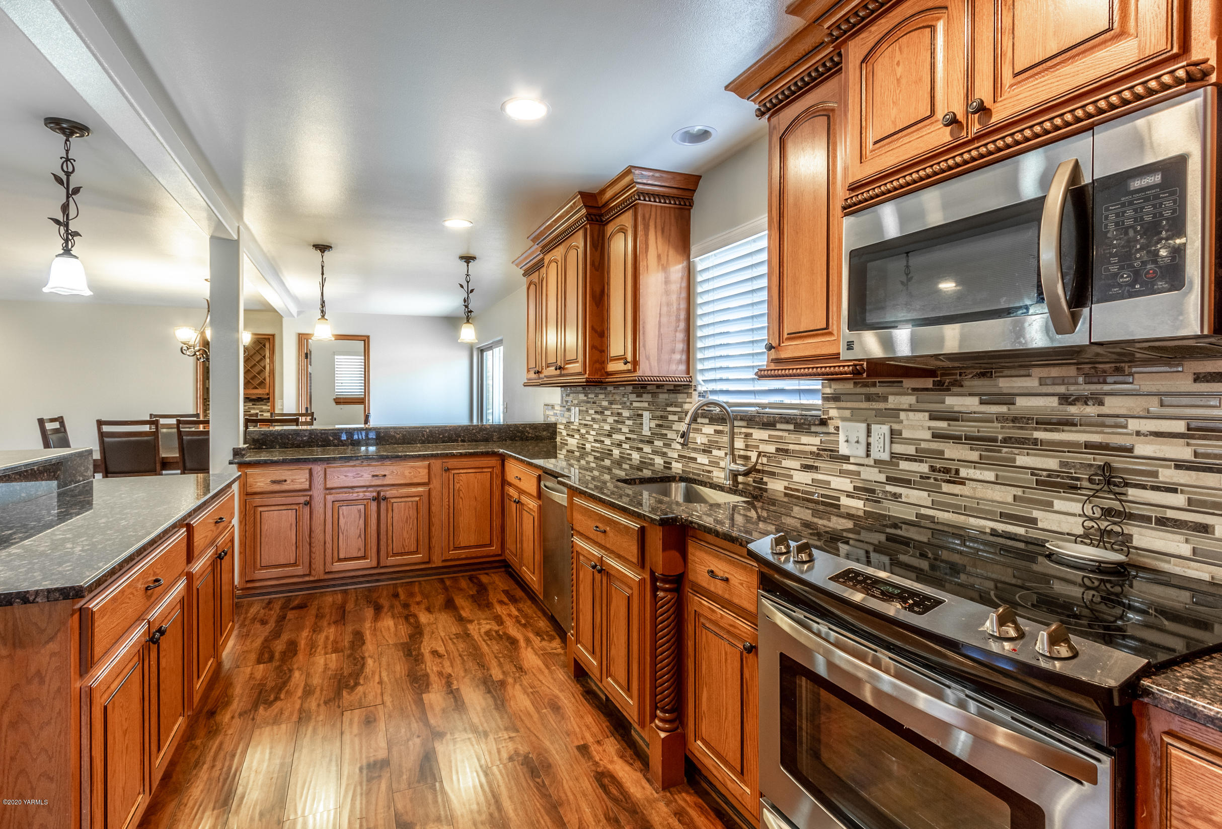 13351 Wide Hollow Road Yakima, WA 98908 - Photo 7 of 31 a kitchen with stainless steel appliances a stove a sink and a microwave