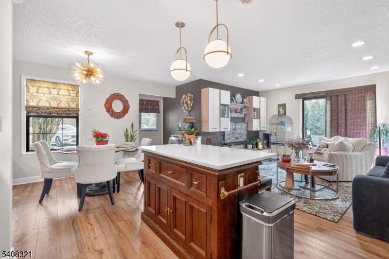 400 Daisy Court Jackson, NJ 08527 - Photo 13 of 29 a living room with a kitchen island furniture a chandelier and a large window