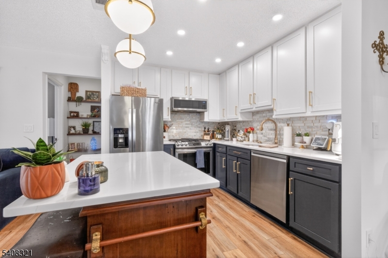 400 Daisy Court Jackson, NJ 08527 - Photo 9 of 29 a kitchen with granite countertop stainless steel appliances a sink and a refrigerator