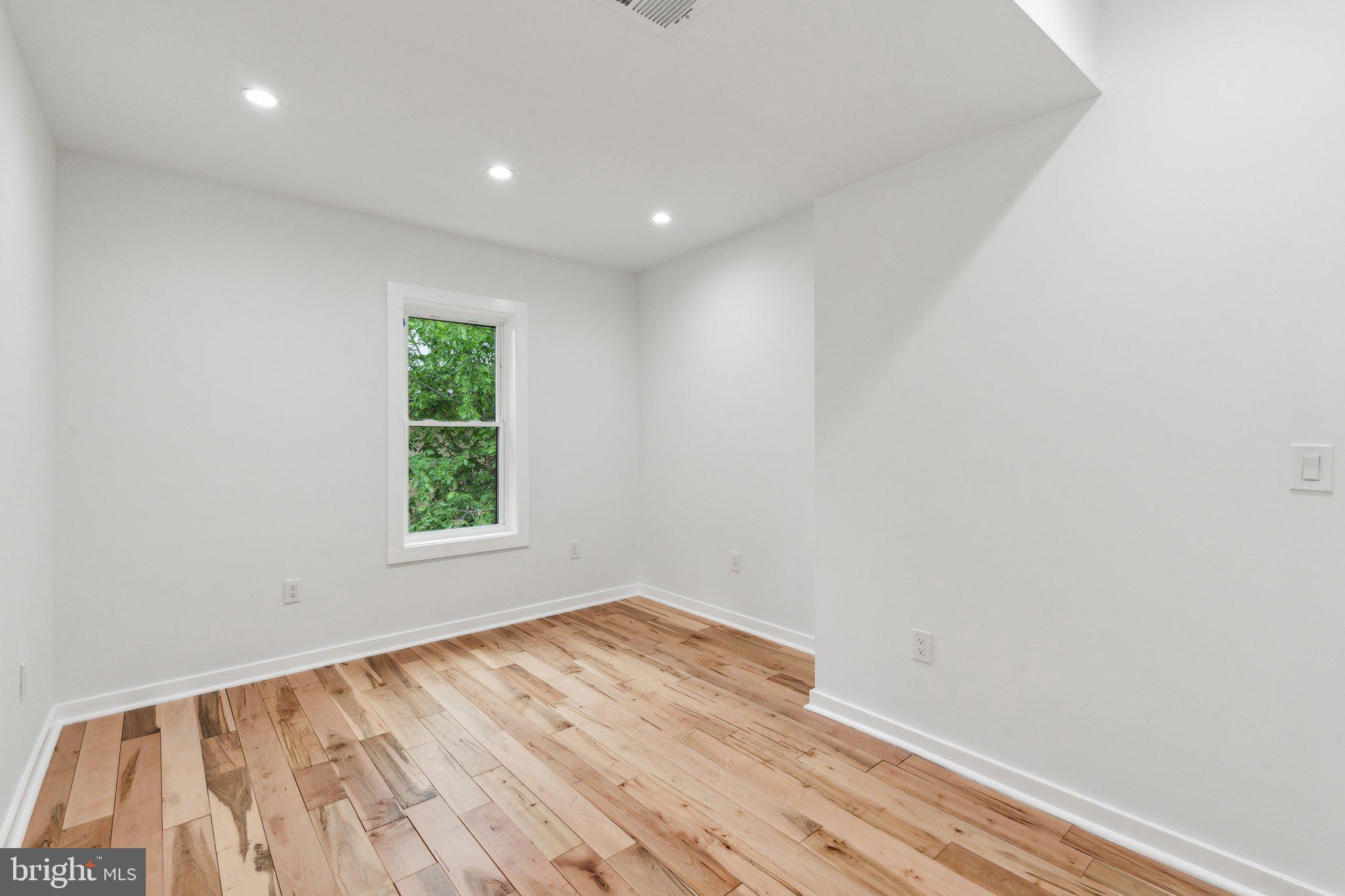 660 Columbia Road Northwest Washington, DC 20001 - Photo 14 of 44 an empty room with wooden floor and windows
