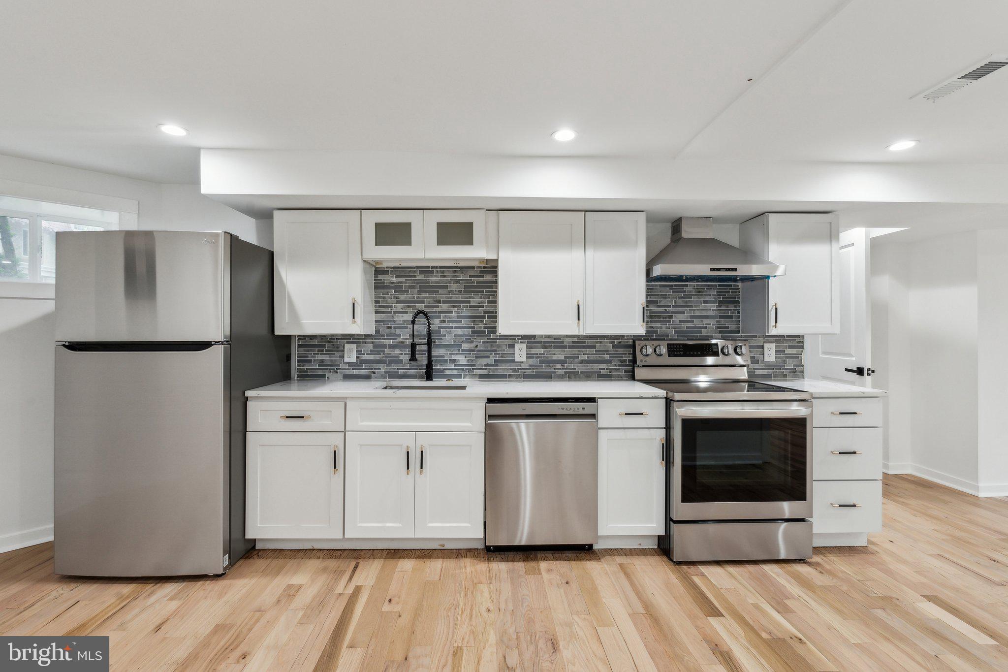 660 Columbia Road Northwest Washington, DC 20001 - Photo 28 of 44 a kitchen with stainless steel appliances granite countertop a stove a sink and a refrigerator