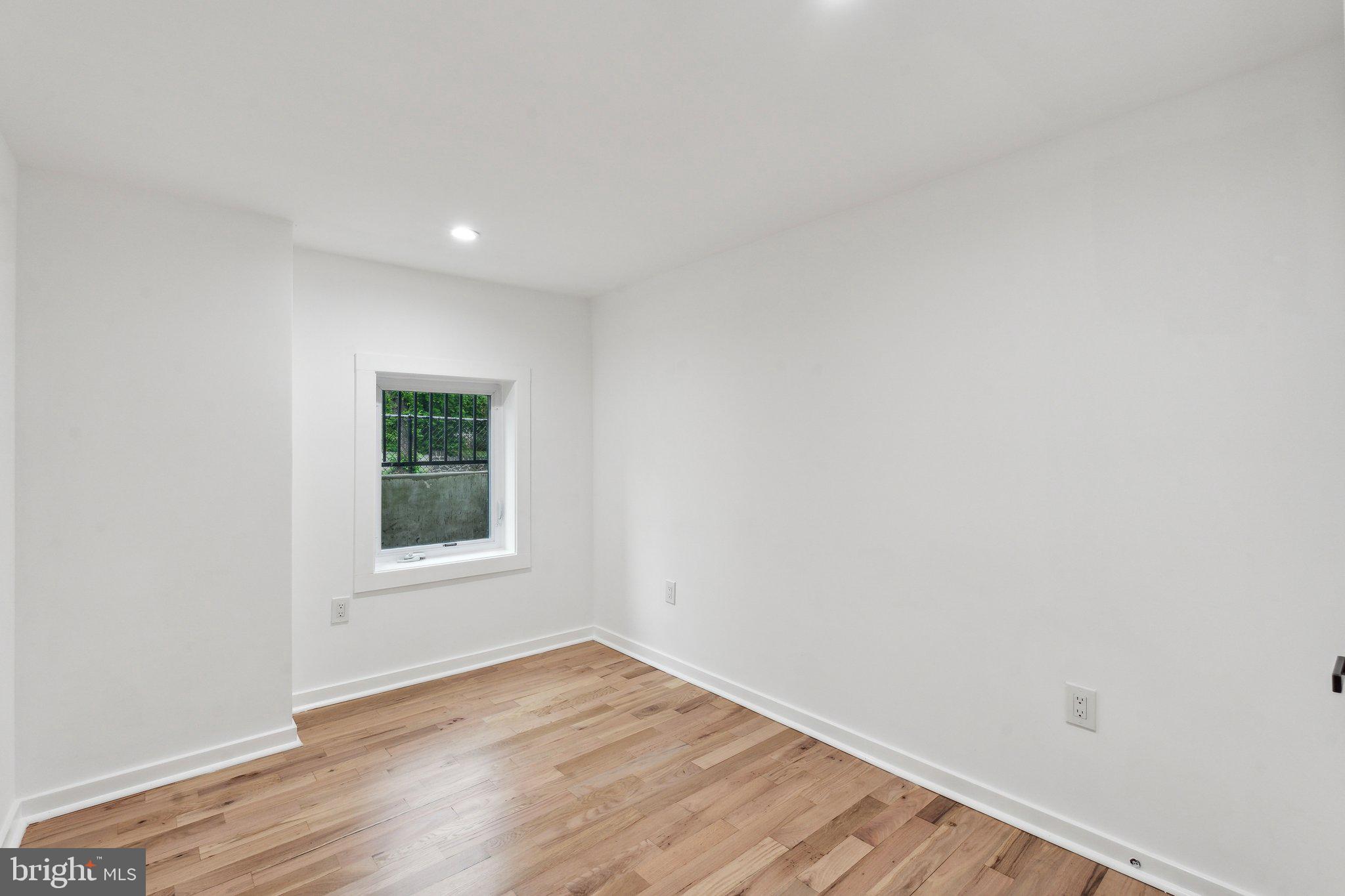 660 Columbia Road Northwest Washington, DC 20001 - Photo 31 of 44 a view of an empty room with wooden floor and a window
