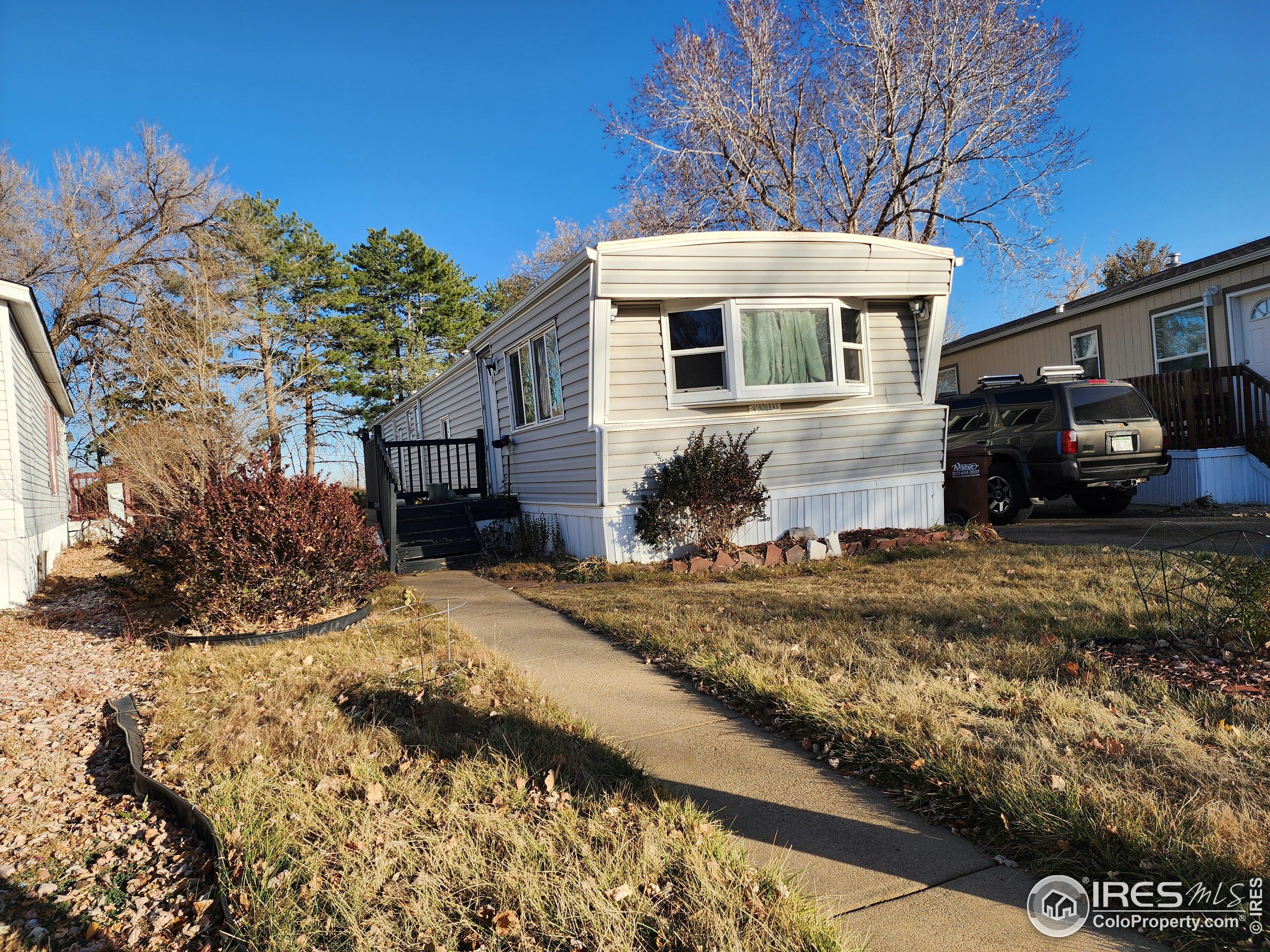 4500 19th Street, Unit 111 Boulder, CO 80304 - Photo 13 of 17 a view of a white house with a yard covered with snow