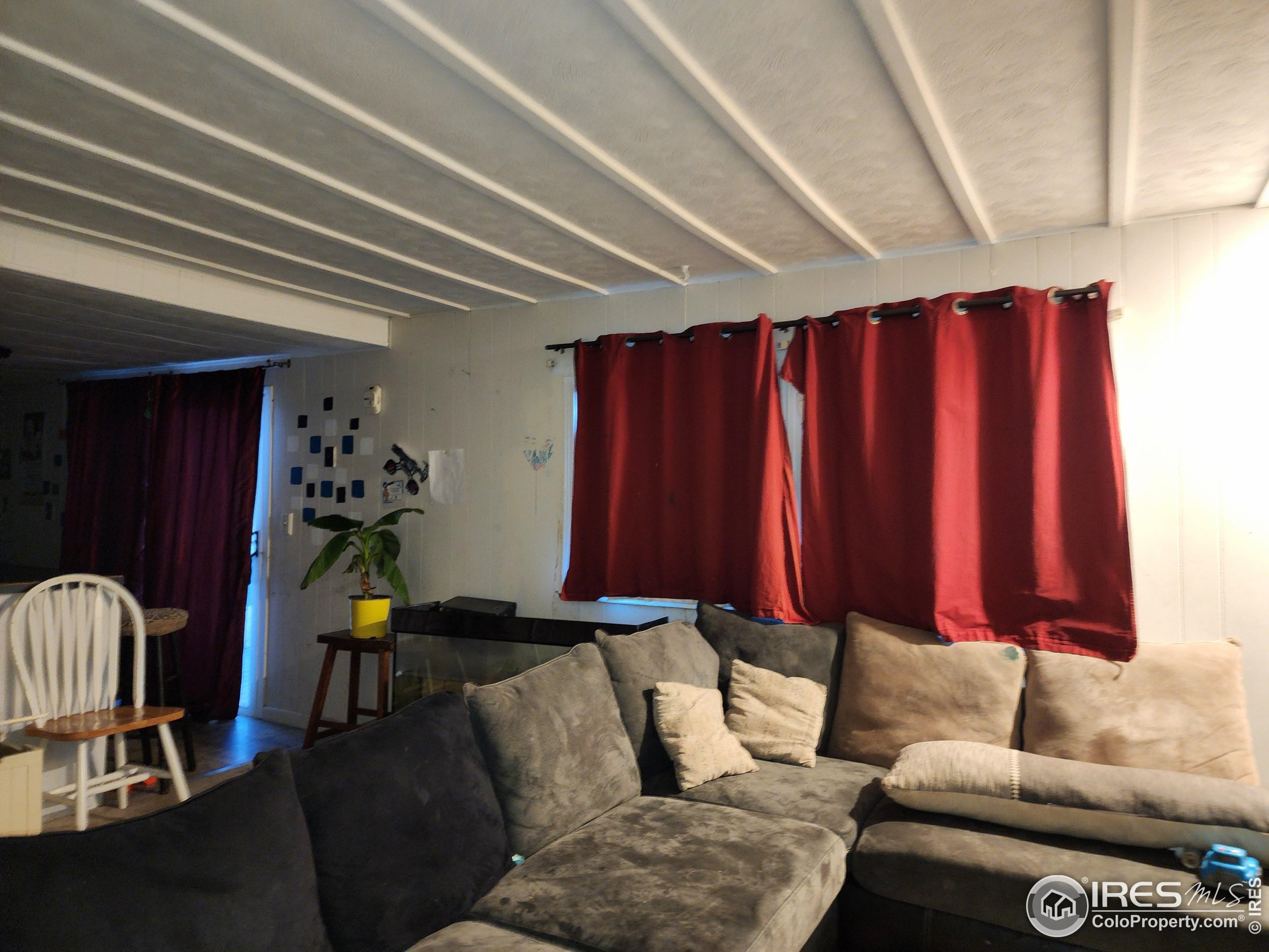 4500 19th Street, Unit 111 Boulder, CO 80304 - Photo 5 of 17 a living room with furniture a lamp and a window