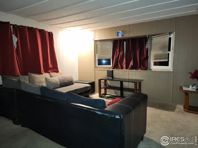 a living room with furniture a closet and a large mirror