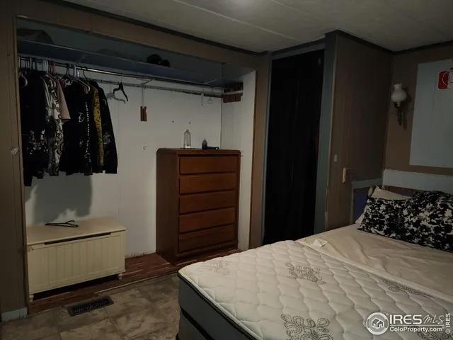 a bedroom with a bed and a closet