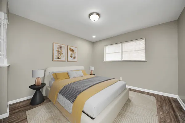 a bedroom with a large bed and a window
