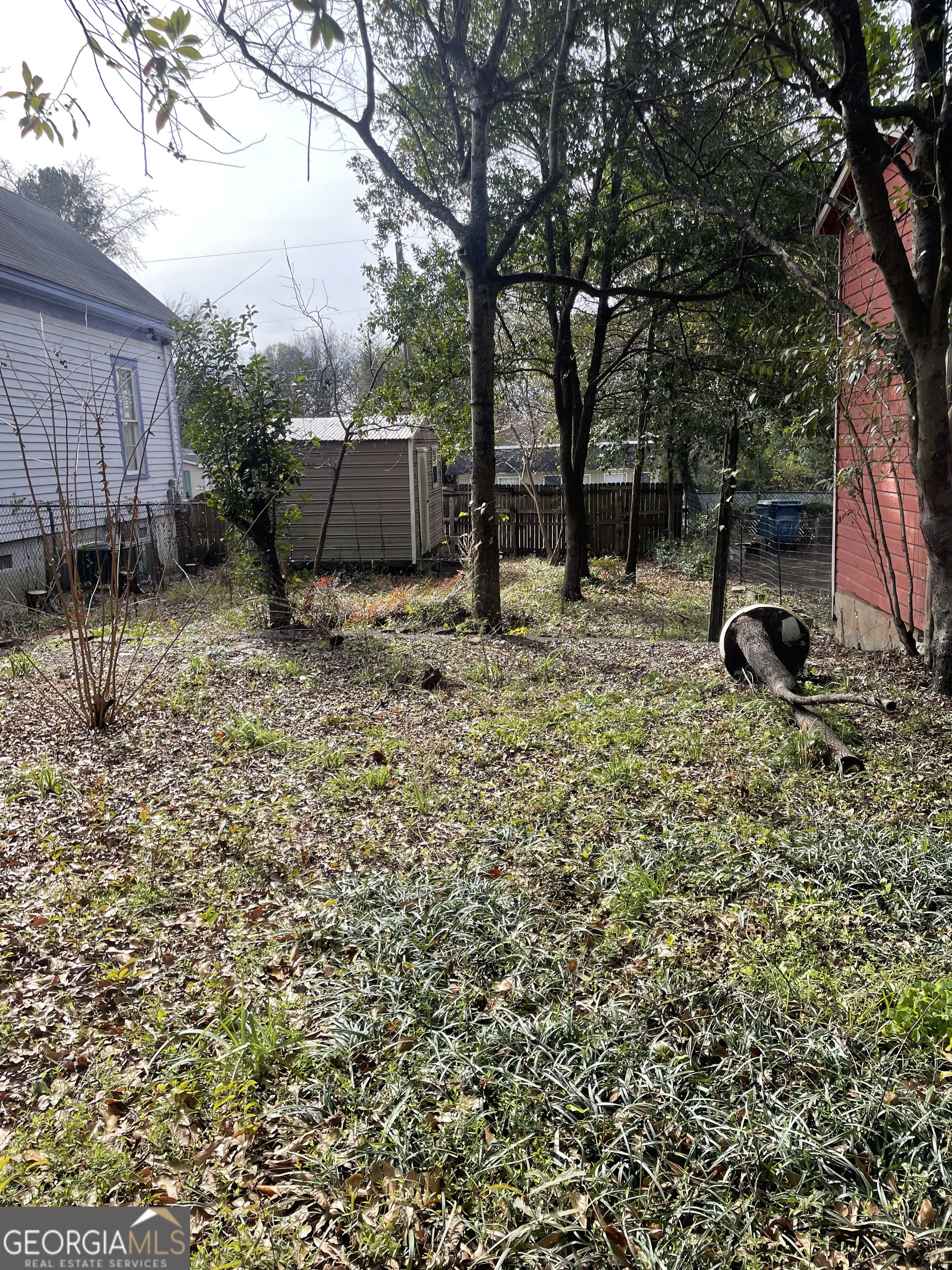1083 Elm Street Macon, GA 31201 - Photo 5 of 5 a view of backyard with wooden fence and a large tree