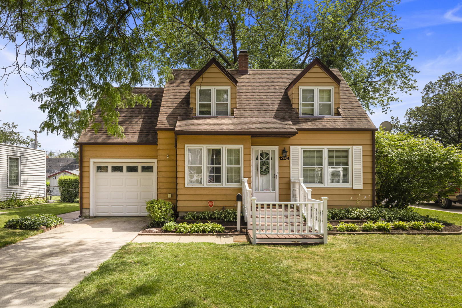 1204 Oneida Street Joliet, IL 60435 - Photo 1 of 30 a front view of a house with a yard and porch