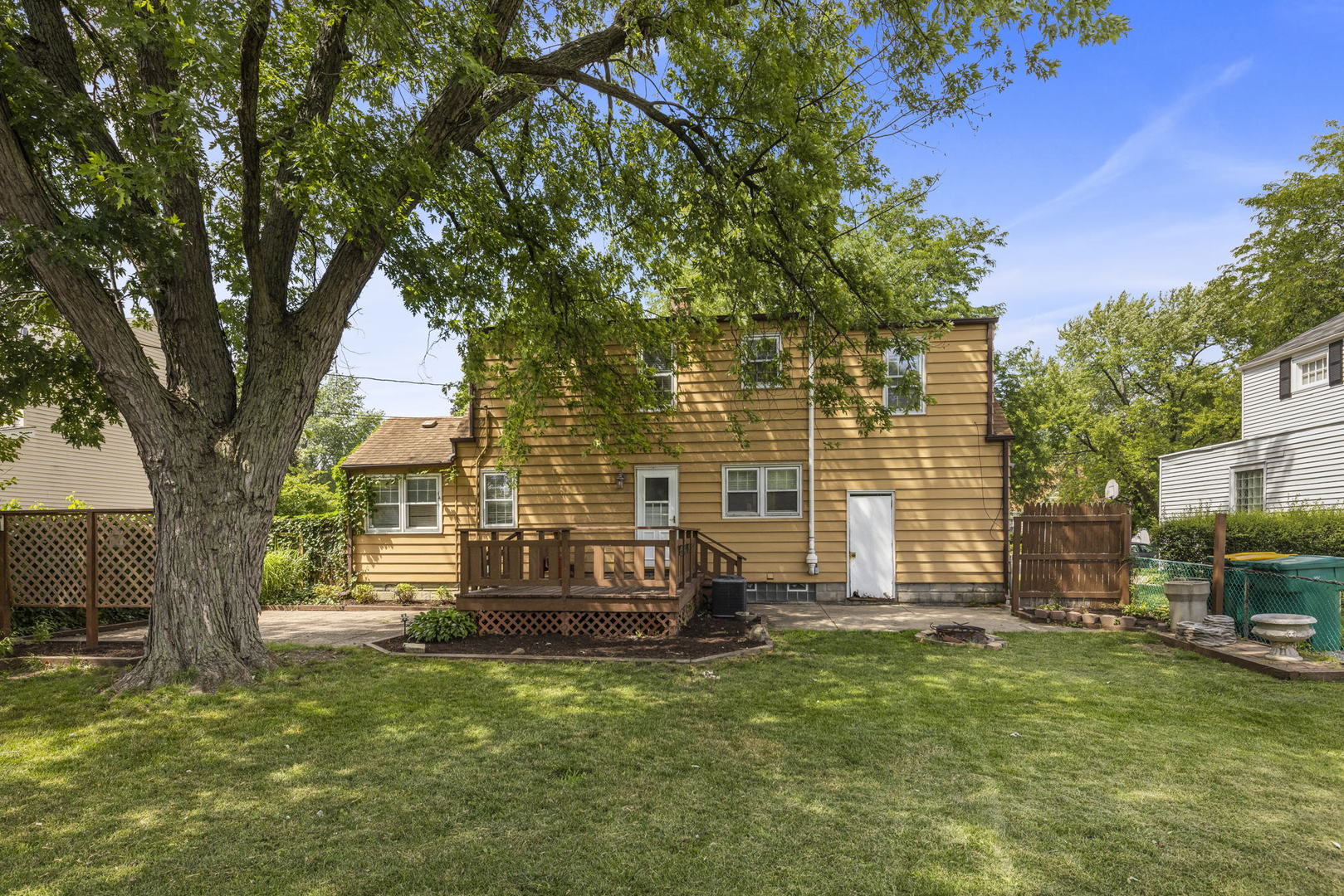 1204 Oneida Street Joliet, IL 60435 - Photo 23 of 30 a view of a house with backyard and a tree